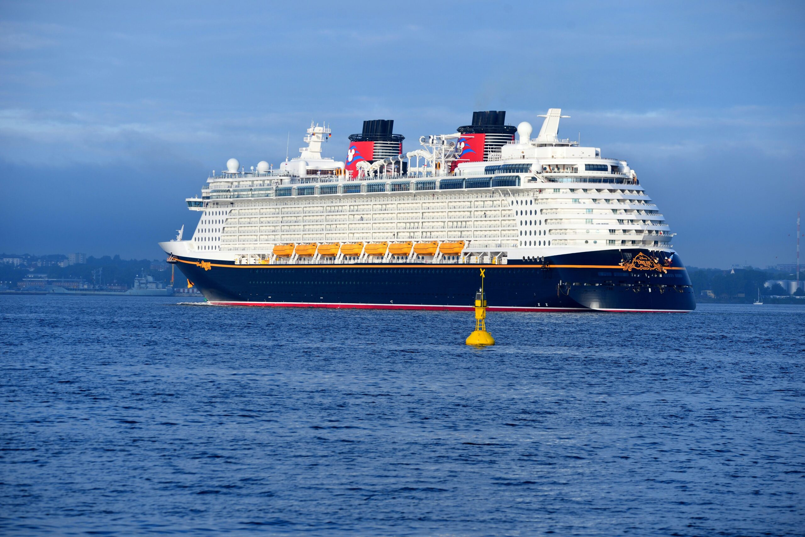 A large cruise ship sailing in open waters under a clear blue sky, perfect for travel enthusiasts.