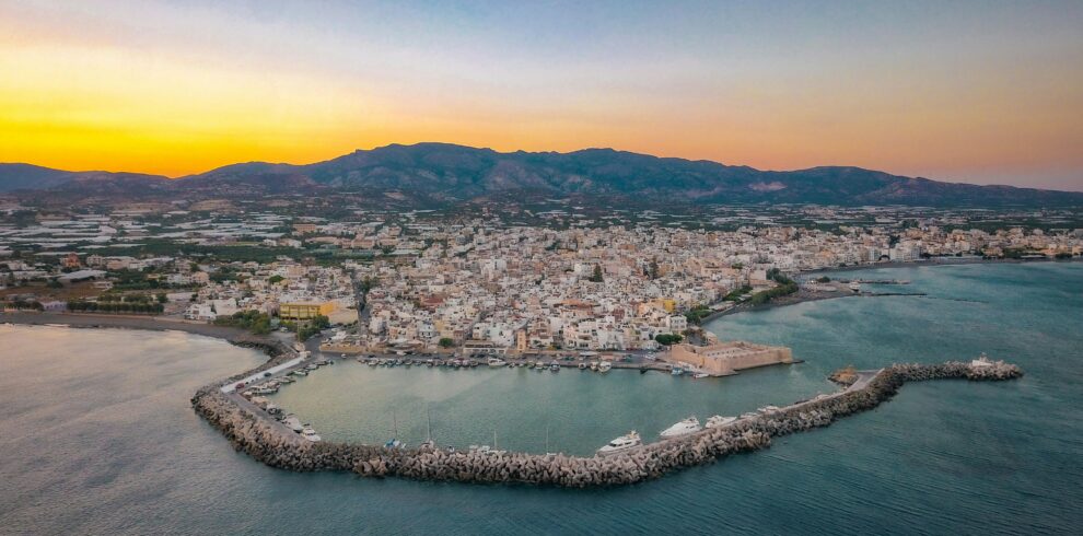 Breathtaking aerial shot of Ierapetra harbor and cityscape during the sunset in Greece.