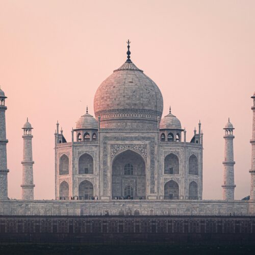 Beautiful view of the Taj Mahal at sunrise, showcasing its stunning architecture and historical significance.