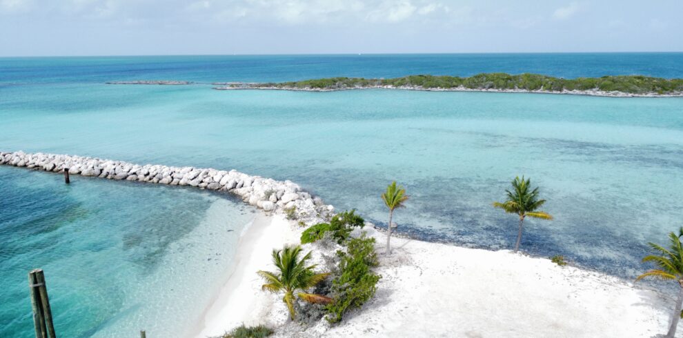 Stunning aerial shot of a tropical beach with pristine white sand and vivid turquoise waters, perfect for a serene getaway.