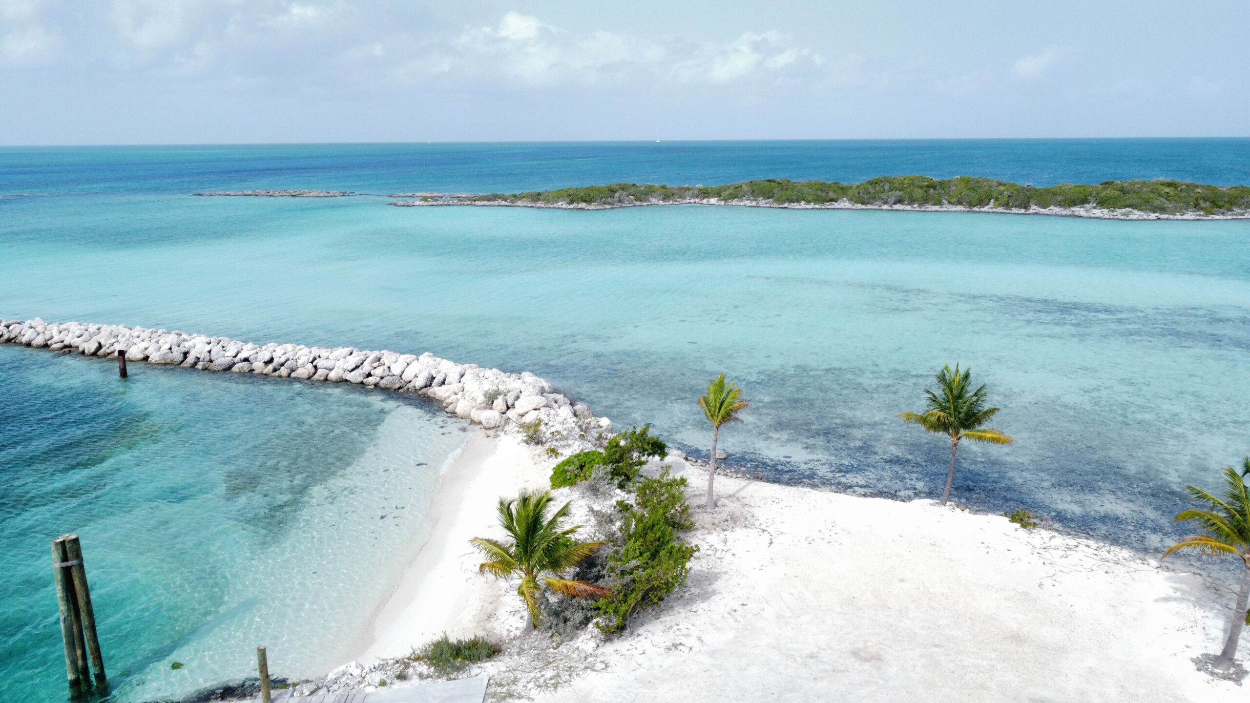 Stunning aerial shot of a tropical beach with pristine white sand and vivid turquoise waters, perfect for a serene getaway.